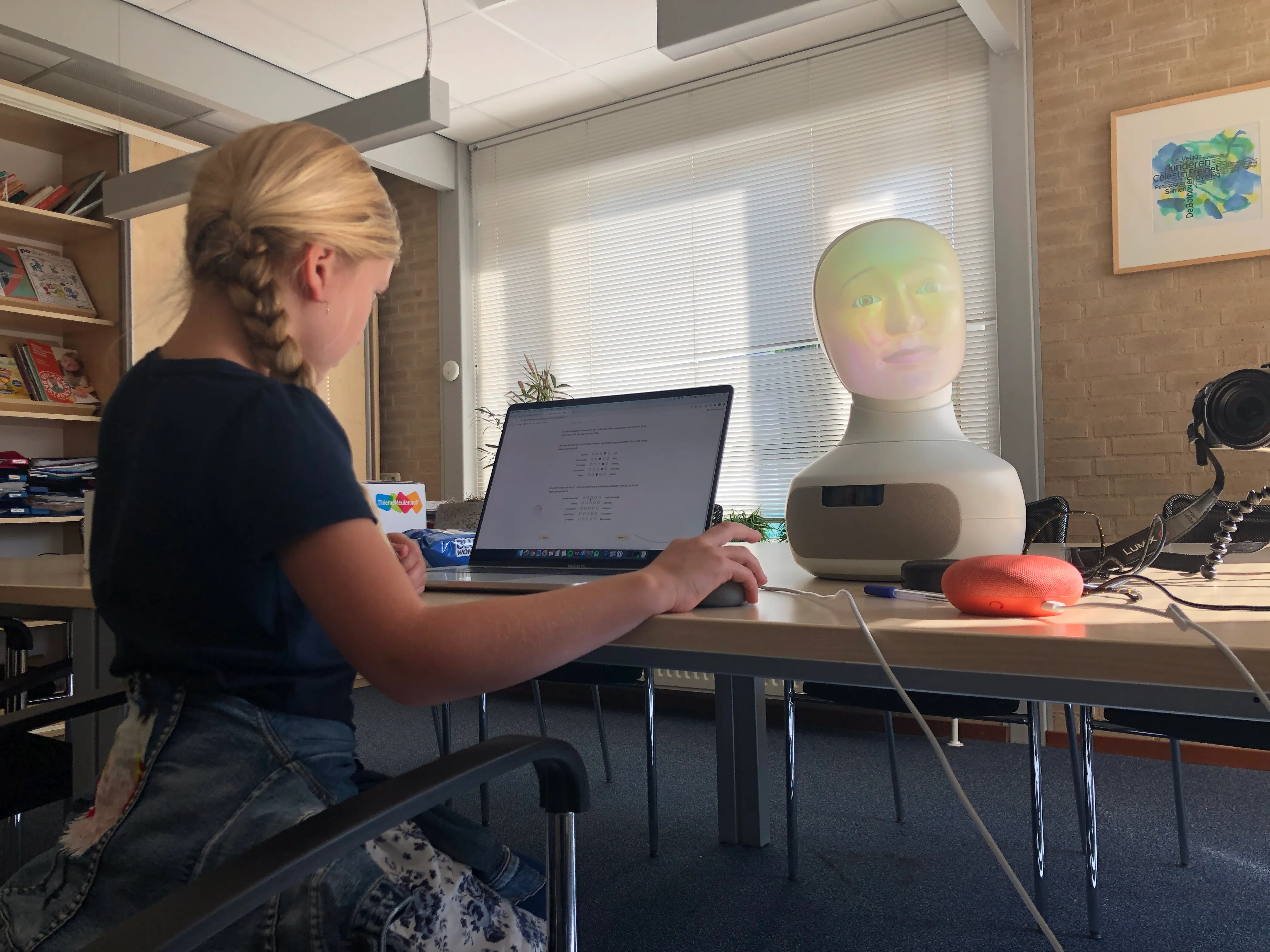A child filling in the questionnaire after interacting with a robot.